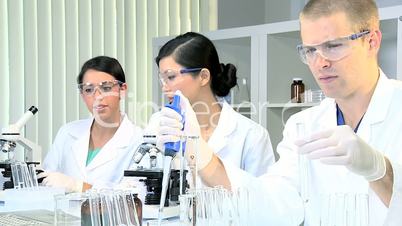 Three Research Students Working in Medical Laboratory