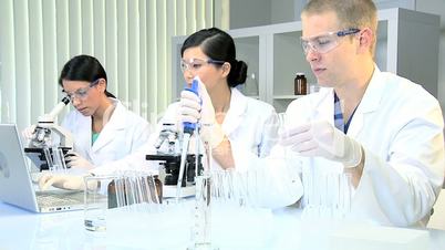 Three Student Medical Researchers in Laboratory