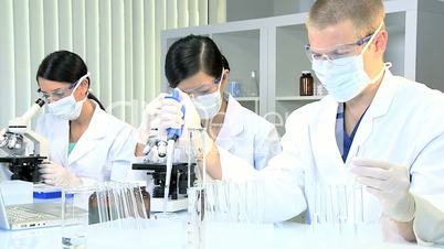 Three Medical Researchers in Laboratory