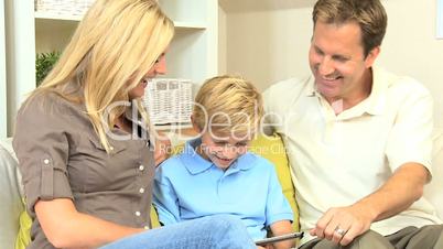 Young Boy and his Parents With a Wireless Tablet