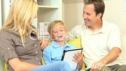 Young Parents and Son Using Wireless Tablet