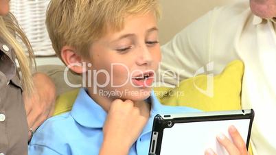 Little Caucasian Boy Using Wireless Tablet at Home