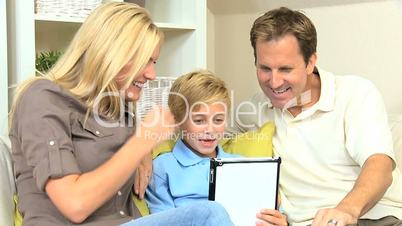 Young Boy and his Parents With a Wireless Tablet