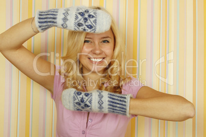Beautiful young woman in mild winter mittens