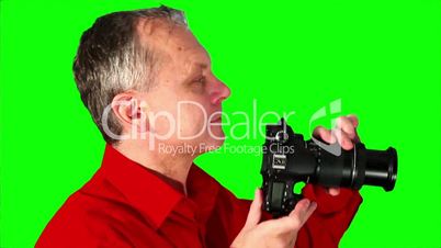 Close-up photographer on a green screen
