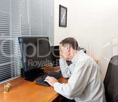 Senior man at computer desk