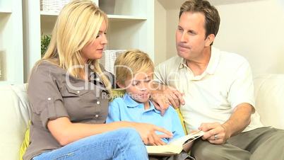 Young Parents Listening to Their Son Reading