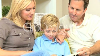 Little Boy and his Parents Reading a Book