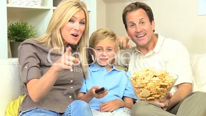 Caucasian Family Watching Movies with Snack Food