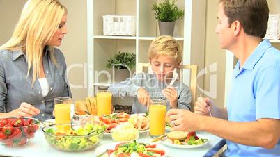 Attractive Caucasian Family Eating Together