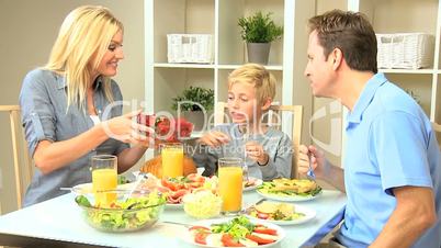 Attractive Caucasian Family Eating Together