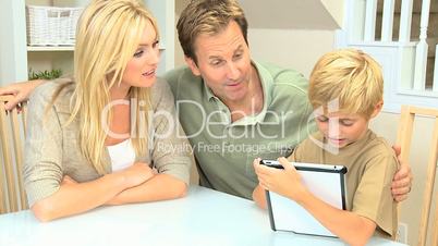 Young Boy and his Parents With a Wireless Tablet