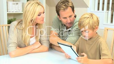 Young Blonde Boy Using Wireless Tablet with Parents