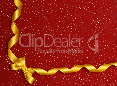 A ribbon and bow on a red background