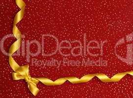 A ribbon and bow on a red background