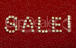 word "SALE" of beads on a red velvet with sequins