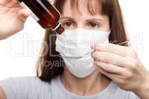 Doctor in mask holding medicine syrup