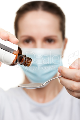 Doctor in mask holding medicine syrup