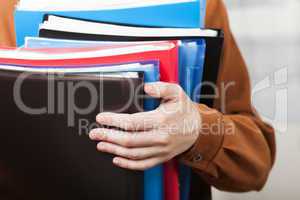 Business paper files in hand