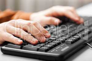 Hand typing computer keyboard