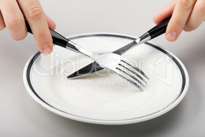 Hand holding fork and knife