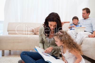 Mother showing photo album to daughter