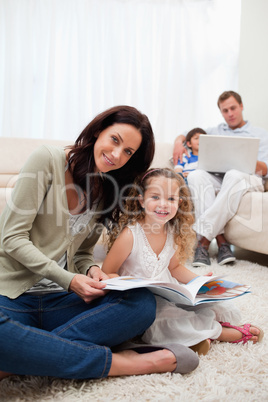 Mother and daughter reading book together