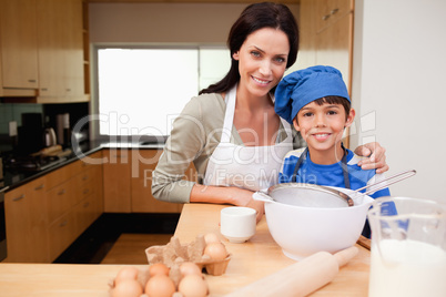 Mother and son preparing cake