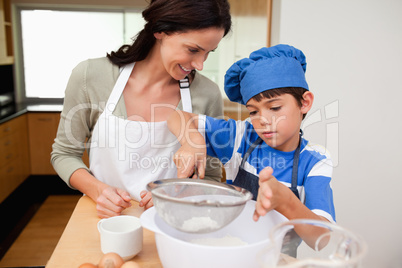 Son and mother preparing dough