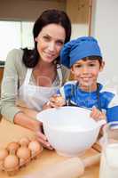 Son and mother baking cake
