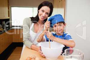 Mother and son having fun preparing dough