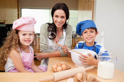 Mother and her children preparing cake