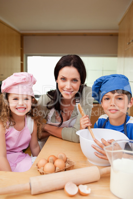 Mother and her children preparing dough