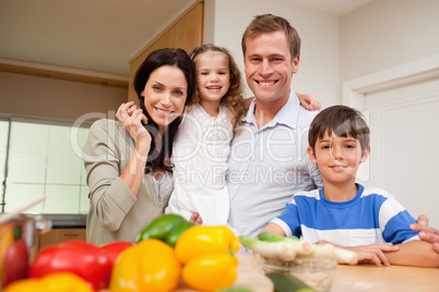 Happy family standing in the kitchen