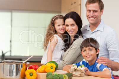 Smiling family standing in the kitchen