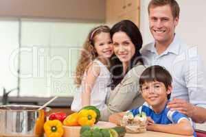 Smiling family standing in the kitchen