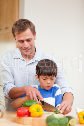 Father and son slicing vegetables