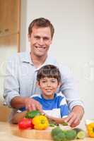 Father and son preparing vegetables