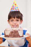 Boy presenting birthday cake