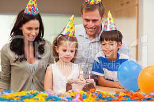 Girl about to blow out the candles on her birthday cake