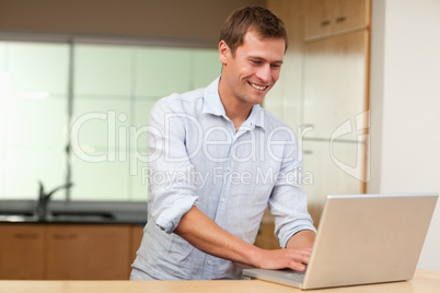 Man working on laptop in the kitchen