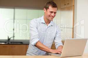 Man working on laptop in the kitchen