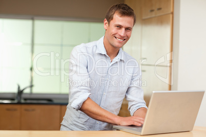 Man surfing the web in the kitchen