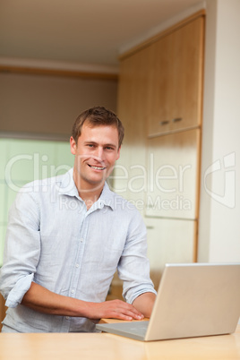 Man using laptop in the kitchen