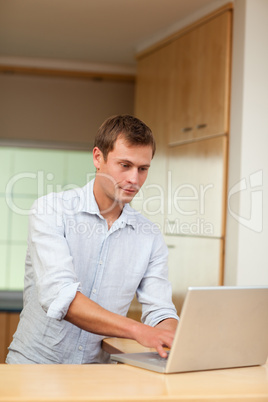 Male working on laptop in the kitchen