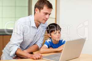 Father and son looking at laptop