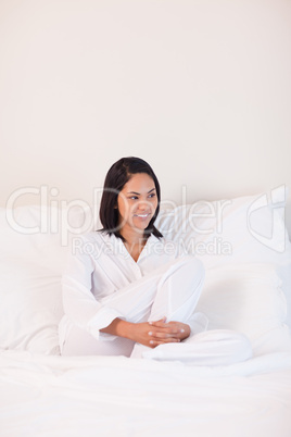 Woman in pajamas sitting on the bed