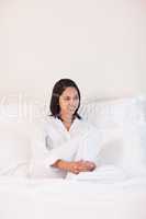 Woman in pajamas sitting on the bed