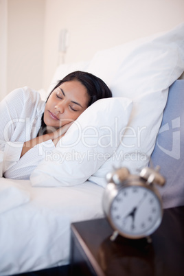 Side view of woman sleeping in her bed