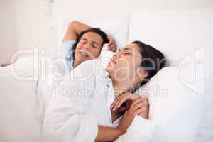 Woman being woken up by snoring boyfriend